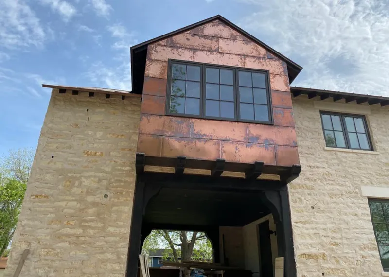 Copper metal panel facade on a stone building for Metal Roof Coating in West Loch Estate